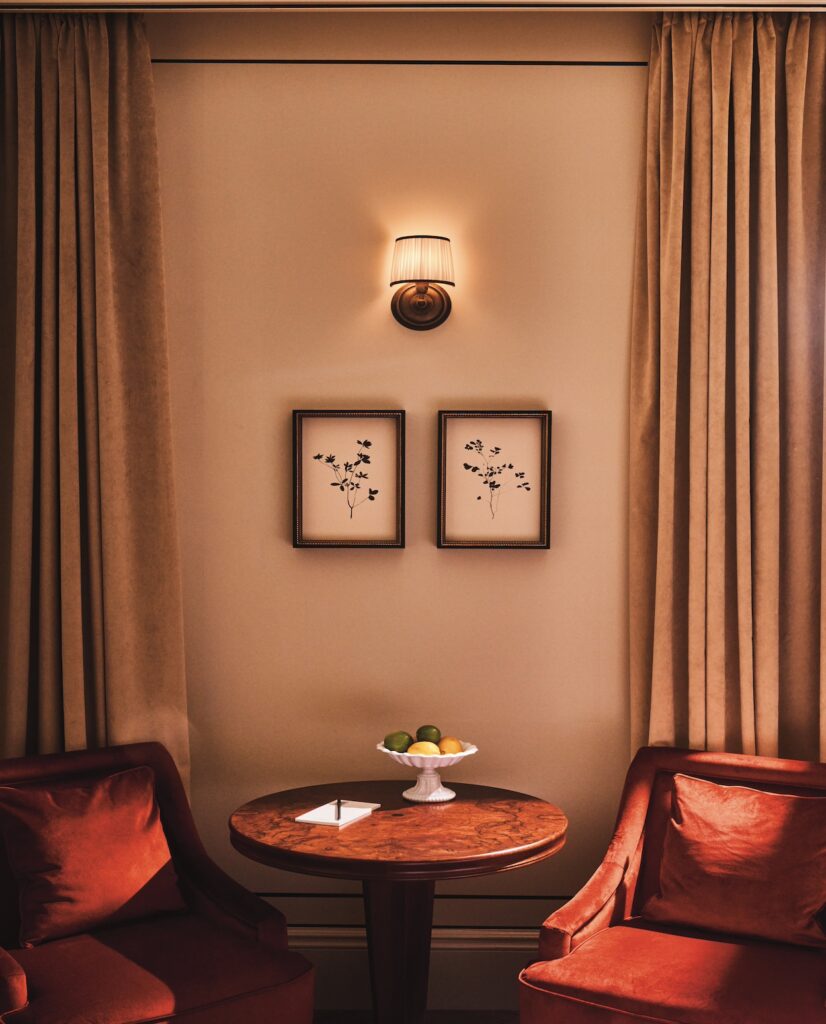 Coffee table and chairs in the Classic Room at The Twenty Two New York, creating a stylish and inviting seating area.