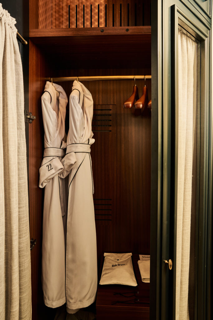 loset view at The Twenty Two New York, featuring plush robes hanging, adding a touch of luxury and comfort.